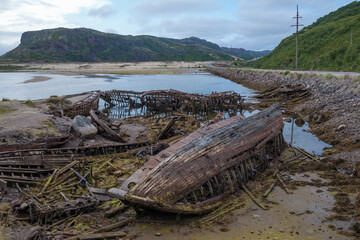 The cemetery of old ships on a cloudy July day. Tourist attraction of Teriberki. Murmansk region, Russia