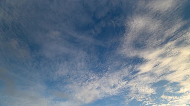 Dusk sky scene, Serene sunset with drifting clouds, Calm evening sky featuring wispy cloud layers, Peaceful twilight sky showcasing flowing cirrus and altocumulus formations