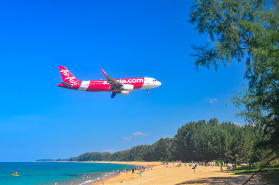 An airplane "Air Asia" comes in for a landing over Mai Khao beach. Phuket, Thailand dec 24, 2025