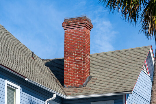 An old red brick chimney on a Florida house