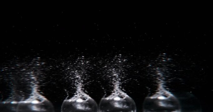 Experience stunning slowmotion capture as water drops create mesmerizing splashes from an object falling into the liquid. Perfect for motion graphics and abstract visuals that inspire creativity
