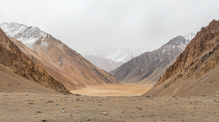 Mountain valley snow desert India landscape with rugged peaks under cloudy sky