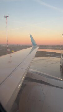 Deicing of airplane before flight. Winter frosty night and ground service at airport during snowfall.
