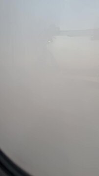 De-icing procedure for big airliner at the international airport. Winter, overcast, cold weather. Large clouds of steam. Jets of sprayer. Special airfield equipment. Ice prevention. Aviation safety.