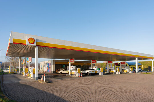 January 24, 2026, Amsterdam, Netherlands - Shell gas station with cars at fuel pumps under a clear blue sky