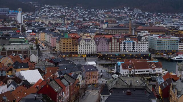 Bergen, Norway. Aerial view of Bergen, Norway at night. Cloudy sunset sky over the city with illuminated roads and car traffic. Time-lapse of Bryggen, zoom in