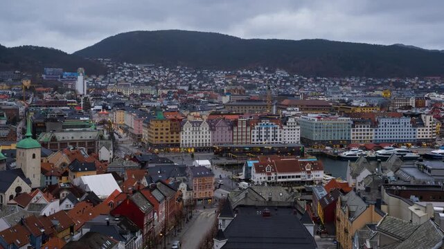 Bergen, Norway. Aerial view of Bergen, Norway at night. Cloudy sunset sky over the city with illuminated roads and car traffic. Time-lapse of Bryggen