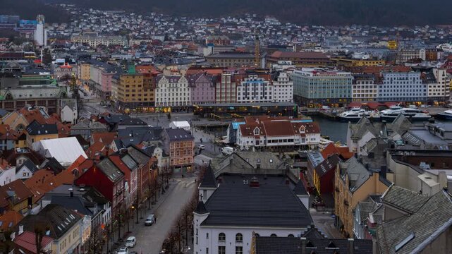 Bergen, Norway. Aerial view of Bergen, Norway at night. Cloudy sunset sky over the city with illuminated roads and car traffic. Time-lapse of Bryggen