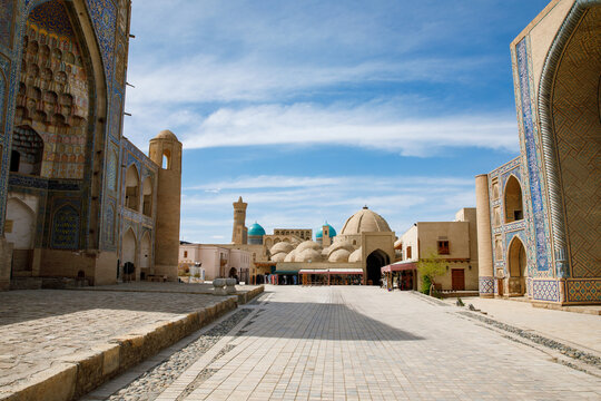 Kosh Madrasah complex in Bukhara with Ulugh Beg and Abdulaziz Khan Madrasas framing Toki Zargaron domes, historic Islamic architecture