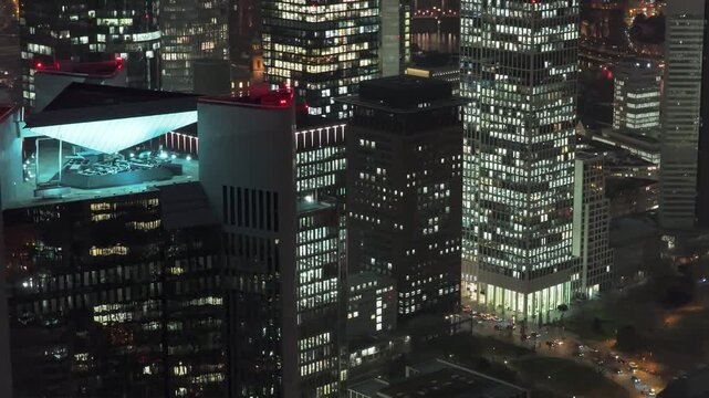 Illuminating aerial perspective showing Frankfurt's downtown financial district at night. Trianon skyscraper and modern buildings are shining