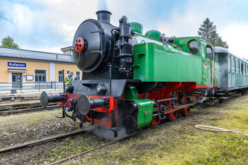 Obraz premium Green steam locomotive waiting at Korenov train station