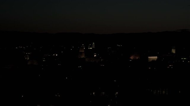 Winter night skyline of Rome from Gianicolo with smoking chimneys and Vittoriano