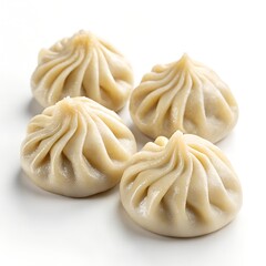four khinkali dumplings on a white background