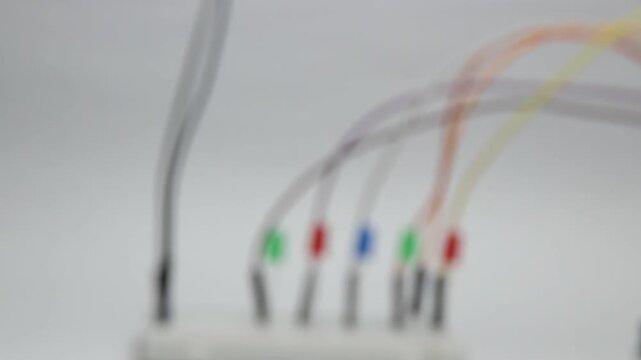 Light emitting diodes blinking on a breadboard with blurred background