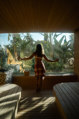 Spa Retreat: Embracing nature's tranquility within a luxurious spa setting, a person finds serenity amidst the harmonious blend of wood and vibrant greenery, a sanctuary of relaxation.