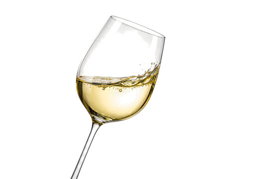 A tilted wine glass with white wine on transparent background
