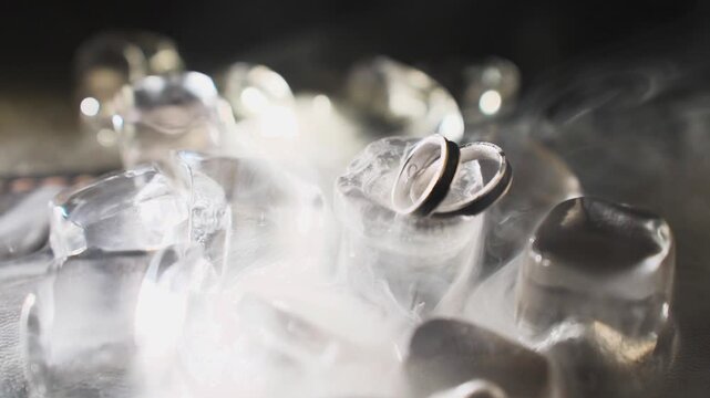 Wedding gold rings captured from an unusual angle, slow motion. Contemporary style