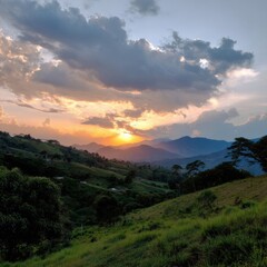 Fototapeta premium Spectacular mountain sunset over rolling hills and lush greenery