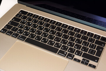 Closeup view of a laptop keyboard featuring Cyrillic characters, highlighting technology and typography details