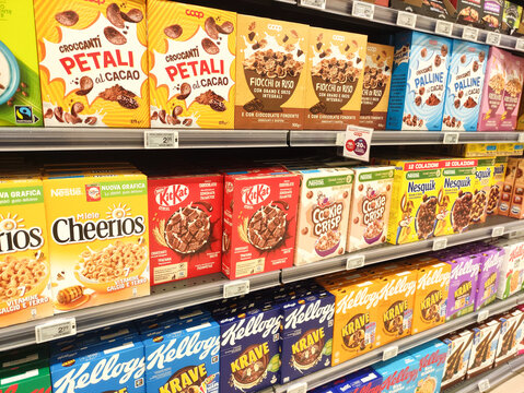 Rome, Italy - January 22, 2026: Assorted breakfast cereal boxes on supermarket shelf including Cheerios, KitKat, and Kellogg's brands in a grocery store aisle