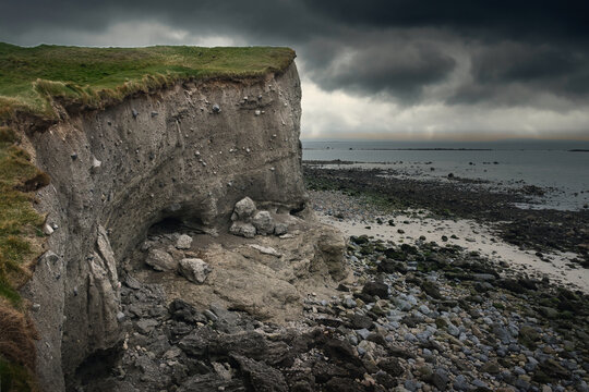 Dramatic Storm Clouds over Silverstrand Beach Coastal Cliffs in Galway Ireland along the Wild Atlantic Way with Rugged Rocks and Ocean, nature landscape background