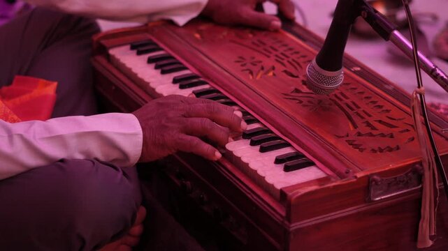 Musician Playing Harmonium in Cultural Event. Traditional Indian Music Performance. Harmonium Being Played in Live Concert. Harmonium in Cultural Event.