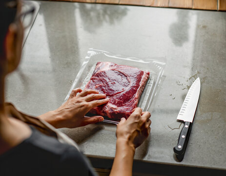 Preparing frozen beef in a modern home kitchen.