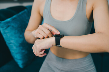 Fitness tracker smartwatch woman exercise technology wrist health monitoring casual clothing indoor lifestyle activity tracker wearable device sport arm digital watch modern fitness healthy