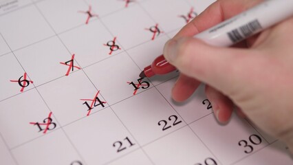 Hand Crossing Out Days On Calendar With Red Marker, CloseUp Showing Repeated X Marks And Finger Motion, Sense Of Urgency And Progress Toward Due Date, Productivity And GoalTracking © bisonov