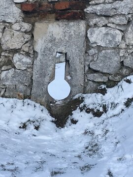 Stone embrasure in medieval castle wall during winter