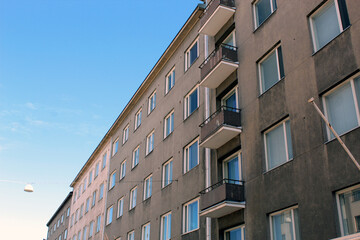 Gray Apartment Building With Balconies In Urban Area