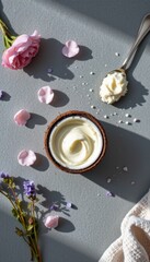 A serene flat lay scene captured from a top down perspective, showcasing a luxurious coconut body scrub set against a muted gray tabletop, The focal point is a rustic
