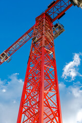 Red Construction Crane Structure Against Blue Sky