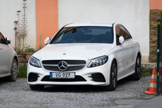 White Mercedes-Benz C-Class W205 saloon car parked on street