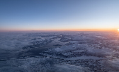 Fototapeta premium Winter landscape aerial view with sunrise and moon