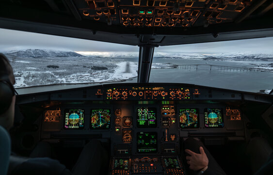Pilot preparing landing airplane approaching snowy troms&oslash; airport