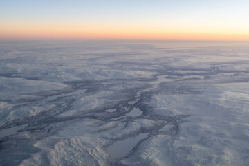 Aerial view snowy arctic landscape at sunrise © Michael