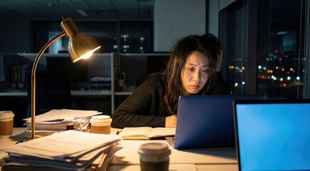 Tired Woman Working Late on Laptop in Office at Night