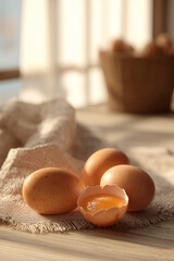 Fresh farm eggs on rustic linen fabric with soft natural light. Organic breakfast concept, natural protein food, and healthy morning nutrition.