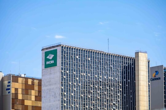 Brasilia, February 1, 2026. Skyscrapers with INCRA and Correios Signs Under Blue Sky
