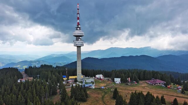 Tower Snezhana on peak of Snezhana covered with spruce forests in Rhodope mountains