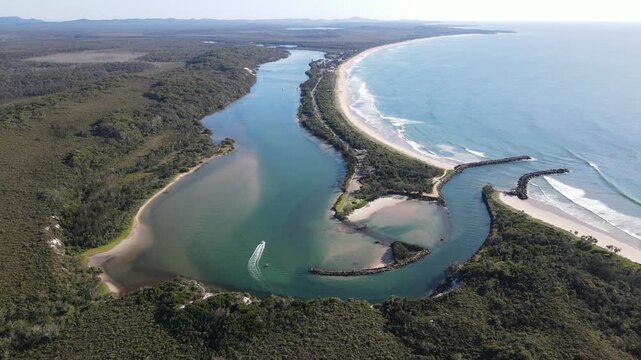 Aerial view of Wooli, New South Wales. Stunning coastal landscape where the Wooli Wooli River meets the Pacific Ocean, turquoise water and sandbars, Australia.