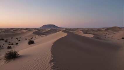 Serene Desert Dunes at Sunset with Distant Mountain.
