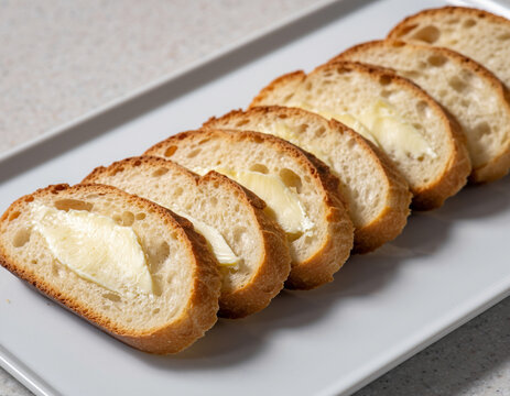 Sliced French baguette with butter
