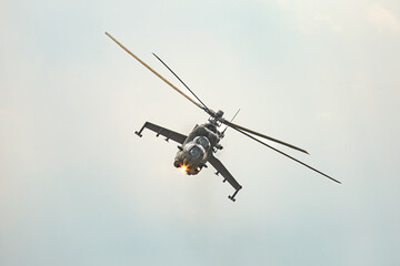 Fototapeta premium Military attack helicopter in forward tilt with weapon systems 