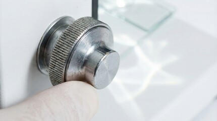 Fototapeta premium Close-Up of Microscope Focus Knob Being Adjusted in a Clean Laboratory