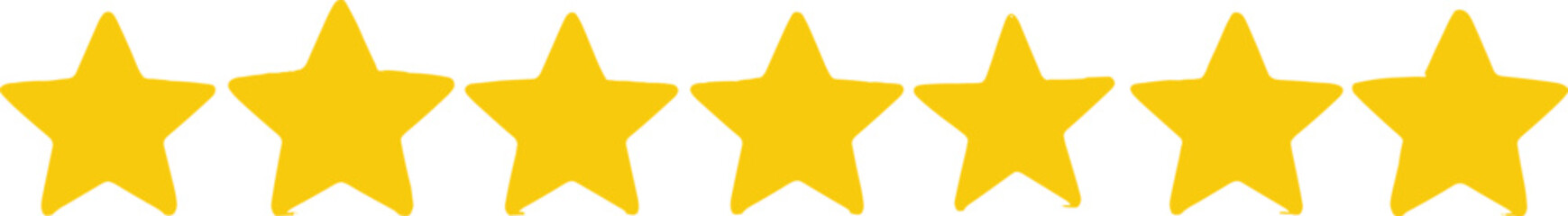 A row of five gold stars aligned horizontally on a plain surface viewed from directly above