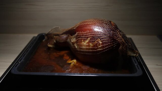 Homemade pork knuckle on baking tray served straight from oven family dinner concept warm kitchen atmosphere