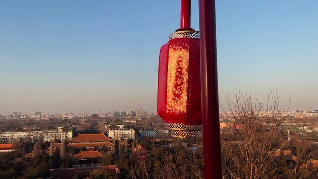 Scenic elevated cityscape frames traditional palace rooftops below and modern Beijing skyline on horizon, with decorative red lantern adding festive Chinese New Year mood.