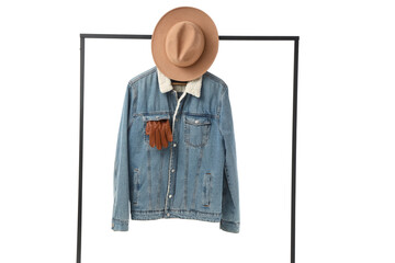 Rack with denim jacket and hat on white background